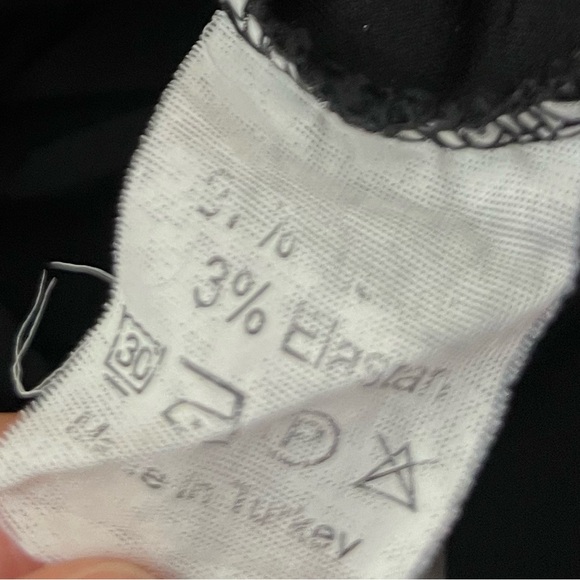 black long-sleeved women's blouse featuring a ruffled neckline and floral lace - Picture 6 of 6